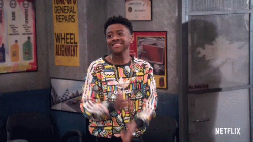 Young Man in Colorful Adidas Shirt at General Repairs Sign