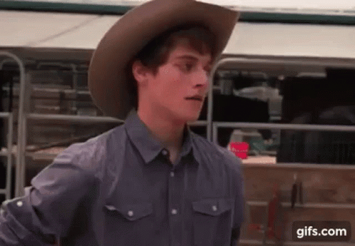 Young Man in Cowboy Hat and Gray Shirt