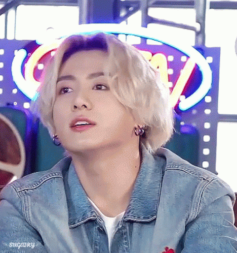 Young Man in Denim Jacket and Earrings