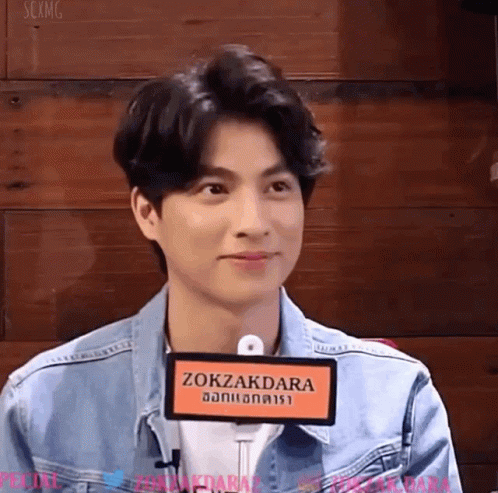 Young Man in Denim Jacket With Zokazdara Sign