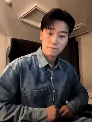 Young Man in Denim Shirt Sitting