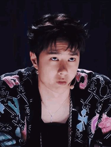 Young Man In Floral Jacket And Necklace GIF