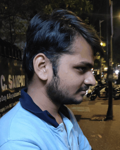 Young Man in Front of C. Sampat Sign
