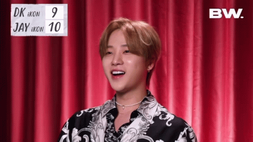 Young Man In Front Of Red Curtain With BW Sign GIF