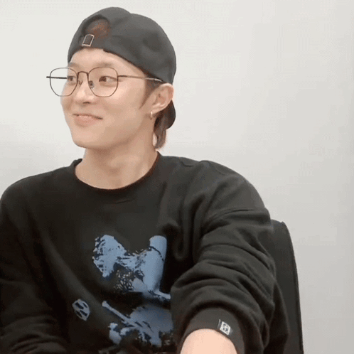 Young Man in Glasses and Baseball Cap Smiling