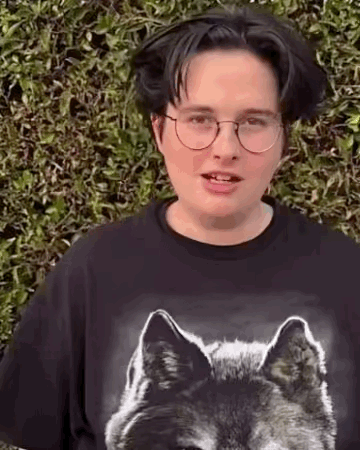 Young Man in Glasses and Black Wolf T-Shirt
