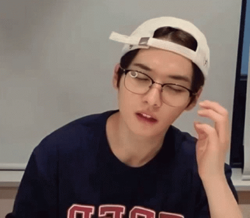 Young Man in Glasses and Cap Making Face