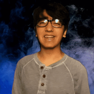 Young Man in Glasses and Grey Shirt Smiling
