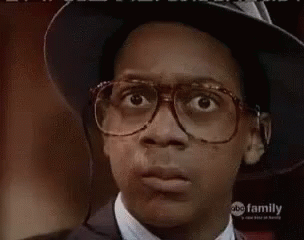 Young Man in Glasses and Hat Making Face