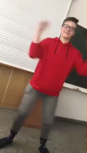 Young Man in Glasses and Red Sweatshirt Dancing