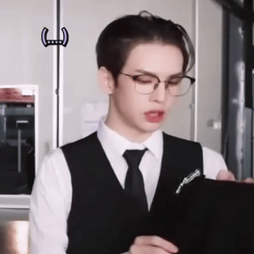 Young Man in Glasses Holding Clipboard