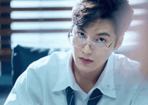 Young Man in Glasses White Shirt and Tie Sitting at Table