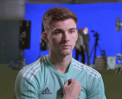 Young Man in Green Adidas Shirt