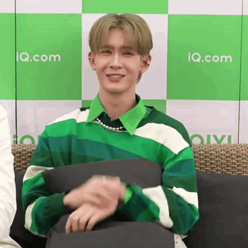 Young Man in Green and White Striped Sweater on Couch