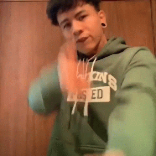 Young Man in Green Hoodie Saying Ed Taking Selfie