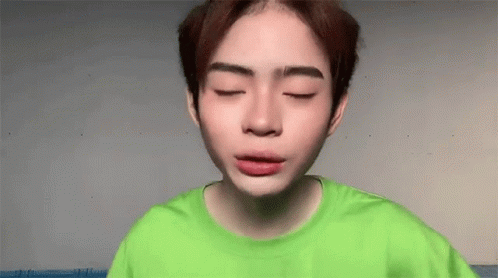 Young Man In Green Shirt With Eyes Closed GIF
