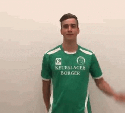 Young Man in Green Soccer Jersey Waving