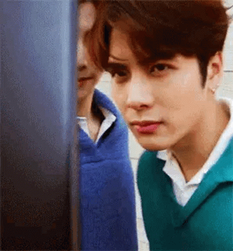 Young Man in Green Sweater Looking at Computer