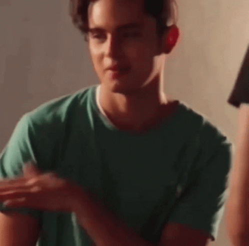 Young Man in Green T-Shirt Holding Fork