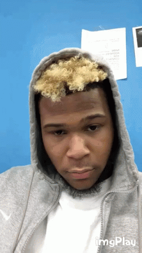 Young Man in Grey Hoodie and White Shirt