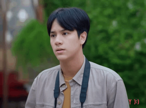 Young Man in Grey Shirt With Black Strap