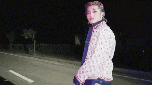 Young Man in Gucci Jacket Walking at Night
