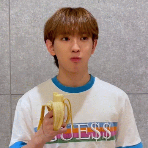 Young Man in Guess Shirt Holding Banana