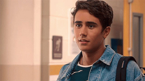 Young Man in Hallway With Backpack