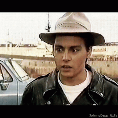 Young Man in Hat and Leather Jacket by Car