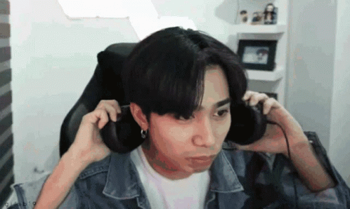 Young Man in Headphones Making Funny Face