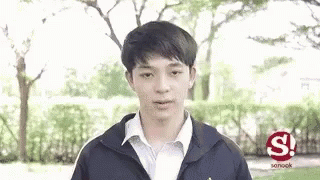 Young Man In Jacket And White Shirt In Park GIF