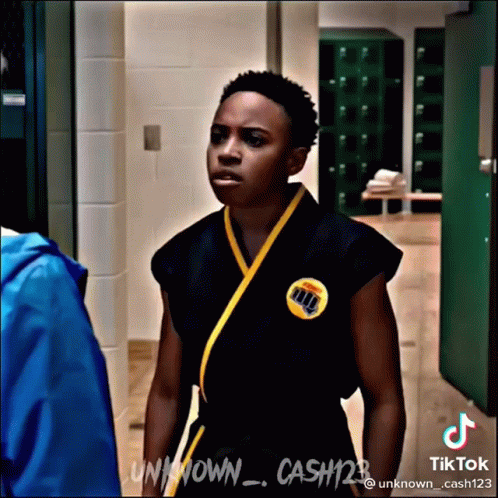Young Man in Karate Uniform in Hallway