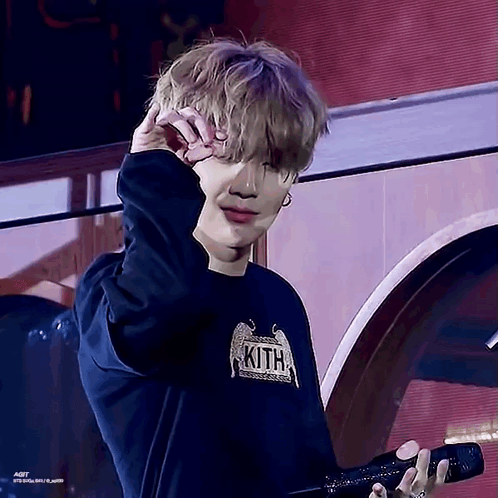 Young Man in Kith Shirt Holding Microphone