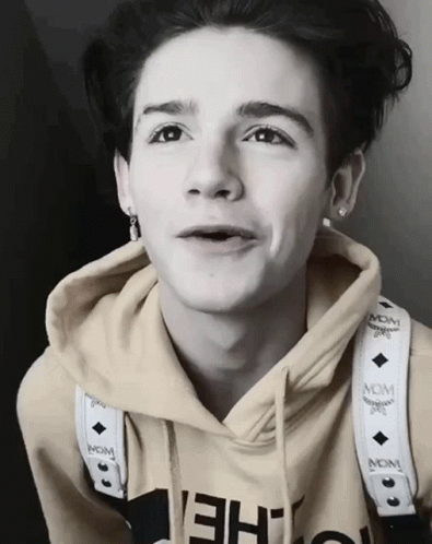Young Man in McM Hoodie With Neck Strap
