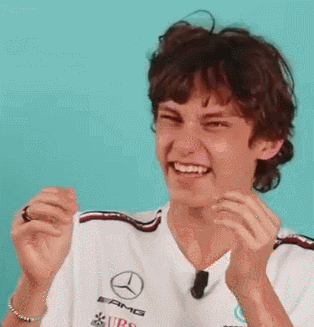 Young Man in Mercedes Shirt Laughing Clapping