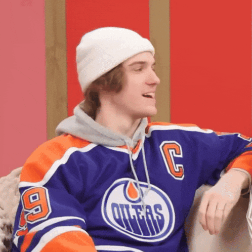 Young Man in Oilers Jersey and White Beanie