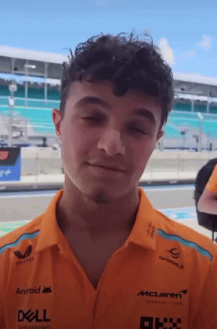 Young Man In Orange Dell And McLaren Shirt GIF