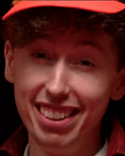 Young Man in Orange Hat Smiling Close Up