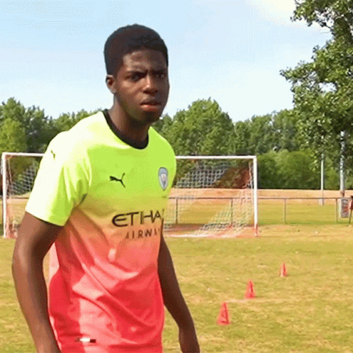 Young Man In Pink And Yellow Etihad Airways Shirt GIF