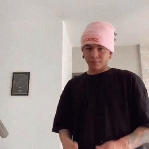 Young Man in Pink Hat and Black Shirt
