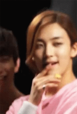 Young Man in Pink Shirt Eating Lemon Slice