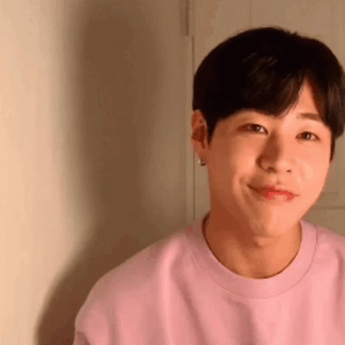 Young Man in Pink Sweater Smiling