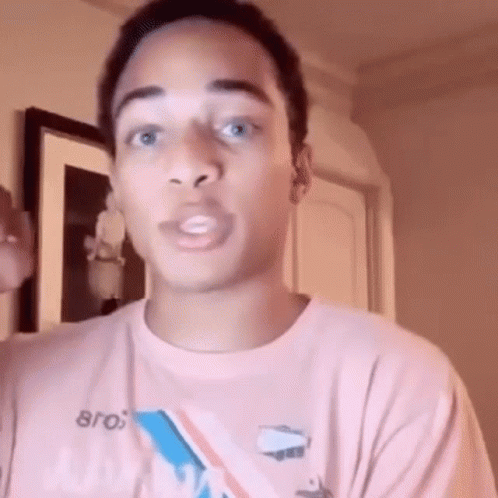 Young Man In Pink T-Shirt Making Funny Face GIF
