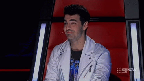 Young Man In Plaid Shirt And Suspenders Laughing GIF