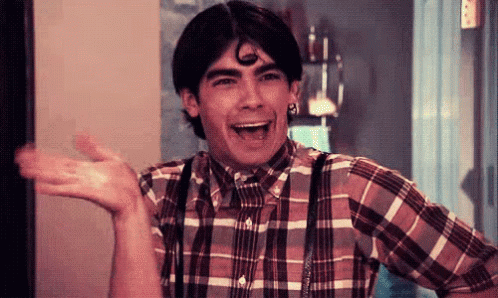 Young Man In Plaid Shirt And Suspenders Laughing GIF