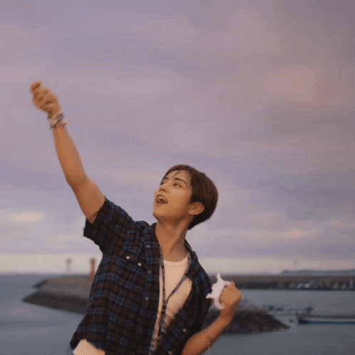 Young Man in Plaid Shirt by Ocean