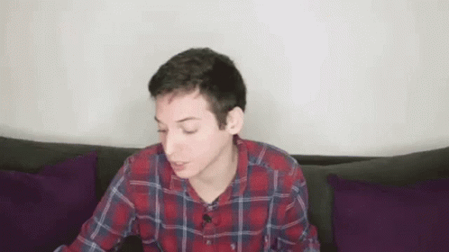 Young Man in Plaid Shirt Drinking Red Cup