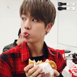 Young Man in Plaid Shirt Eating Hamburger