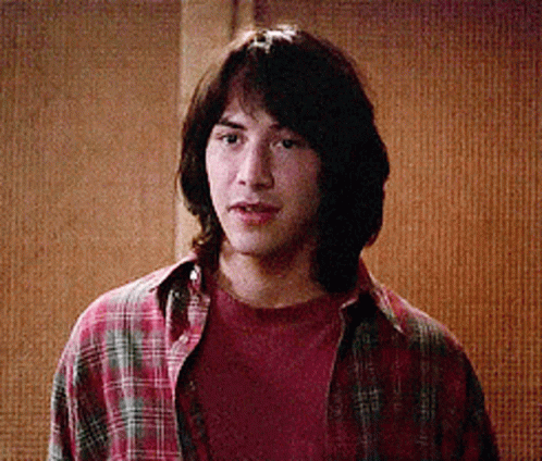 Young Man in Plaid Shirt Looking at Camera