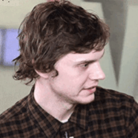Young Man in Plaid Shirt Looking to Side